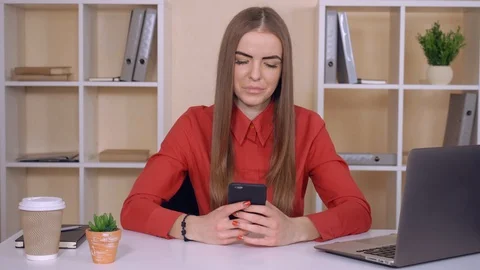 Female texting sms on cellular indoors Stock Footage 85627897