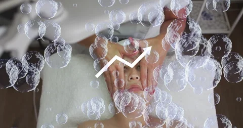Female therapist hands massaging client face in spa, showing floating bubbles Stock Footage 307446253