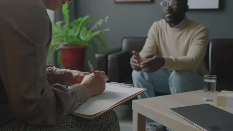 Female Therapist Taking Notes during Consultation with Patient Stock Footage 256022704