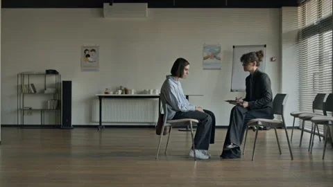 Female Therapist Taking Notes during Counseling Session with Female Client Stock Footage 337245112