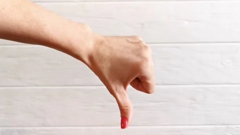 Female thin hand with pink manicure chooses reaction, thumbs up, like or dislike Stock Footage