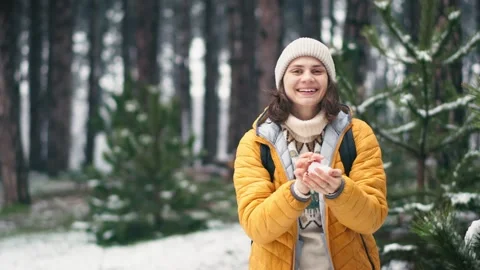 A female throwing snowballs at the camera. Stock Footage 254765467