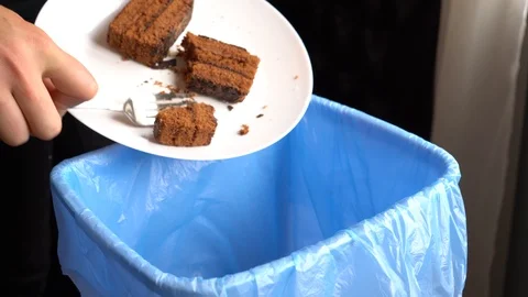 Female throwing the sweet bakery into garbage bin Stock Footage 106321095