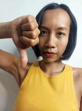 A Female With Thumbs Down Fotos Stock