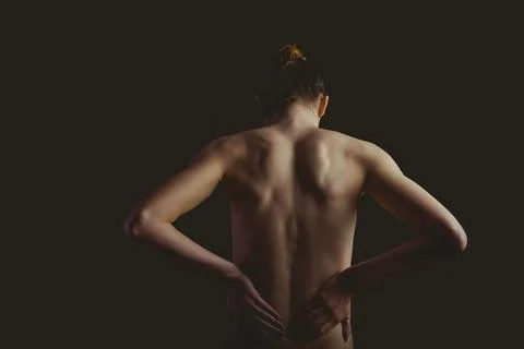 Female torso is being shown in vector art, highlighting back contours on black Stock Photos