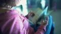 Female tourist looking through magazine, waiting for plane, choosing travel tour HD Footage