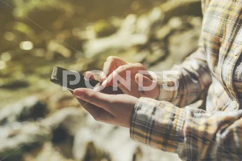 Female tourist using mobile smart phone for GPS navigation Stock Photos