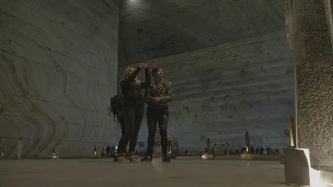 Female tourists having fun while walking among salt walls and sculptures admi Stock Footage 87317780