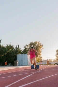 Female track athlete exploding out of sprint blocks Stock Photos