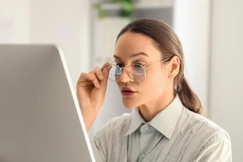 Female trader in eyeglasses working with computer at office, closeup 스톡 사진