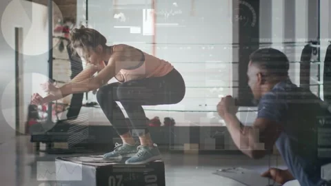 Female trainee performing explosive box jumps for fitness after male coach Stock Footage 331736345