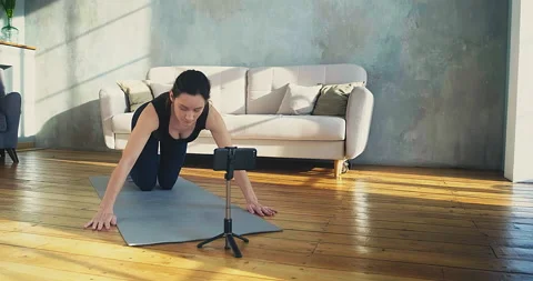 Female trainer does push ups posing for camera on phone Stock Footage 155612171