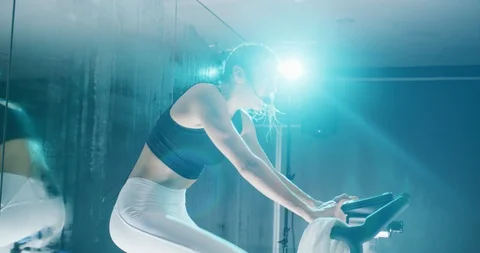 Female trainer leading a spin class Stock Footage 97404159