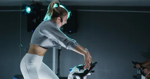 Female trainer leading a spin class Stock Footage 97472591