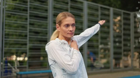Female trainer performing arms exercises for warming up before workout Video stock 252193686