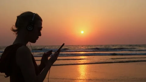 Female traveller using smartphone on the beach. Stock Footage 234969735