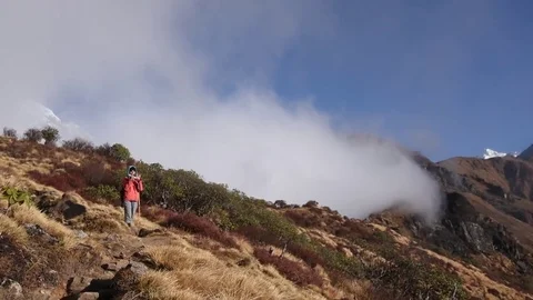 Female Trekker Standing On Mountain As Clouds Roll In - Annapurna Nepal Stock Footage 80618296