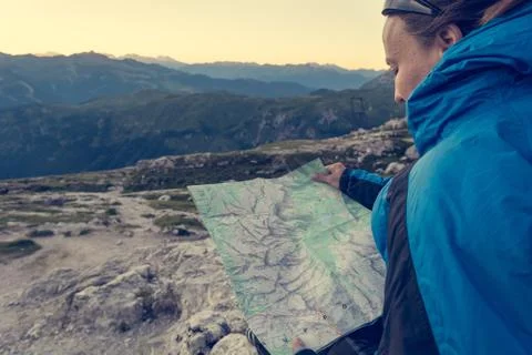 Female trekker studying a map. Stock Photos