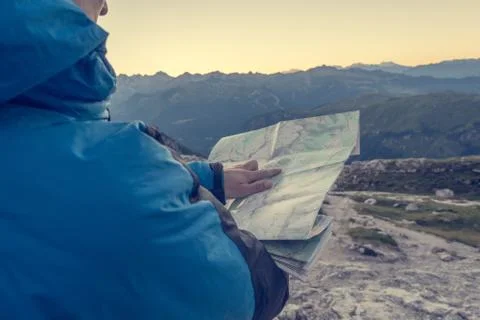 Female trekker studying a map. Stock Photos