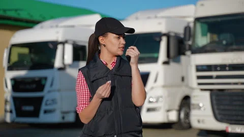 Female truck driver coordinating loading via radio Stock Footage 299746417