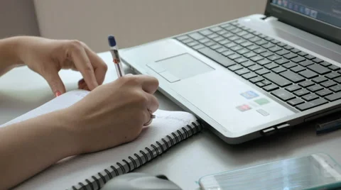 Female types and takes notes in notebook Stock Footage 65219884