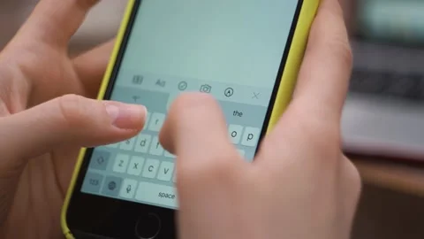 Female types text on phone close-up, sends a message, makes a plan for the day Stock Footage 147443553