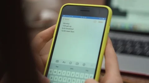 Female types text on phone close-up, sends a message, makes a plan for the day Stock Footage 147443992
