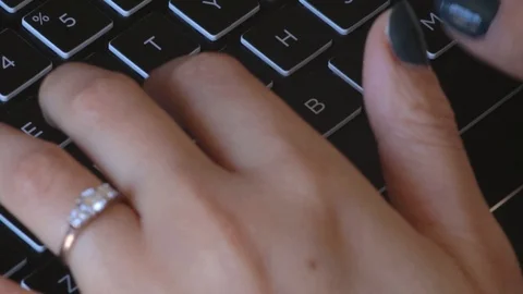 Female typing on a laptop computer Stock Footage 125387171