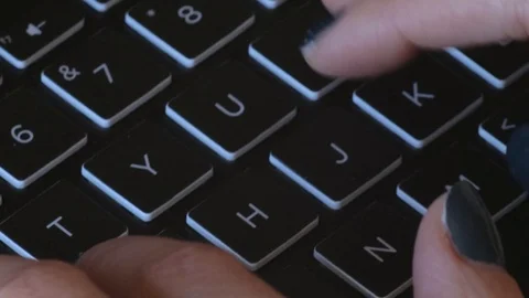 Female typing quickly on a computer keyboard Stock Footage 124353046