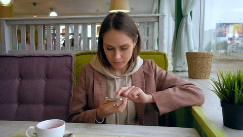 Female use smartphone in cafe. Stock Footage 116860258