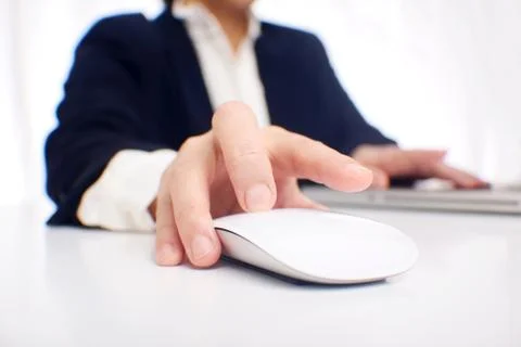 Female using a computer about to click a white mouse  Stock Photos