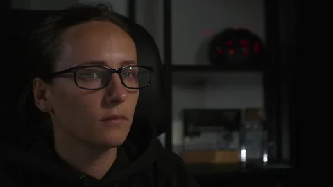 Female is using computer at home workplace at night. Young woman programmer Stock Footage 138082270