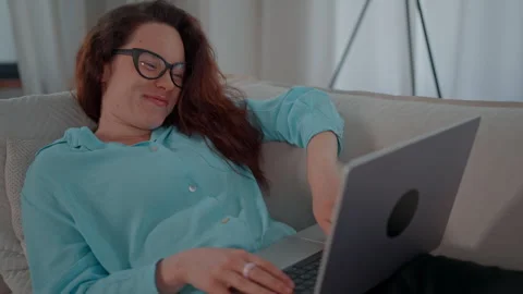 Female using computer in living room Video stock 250324497