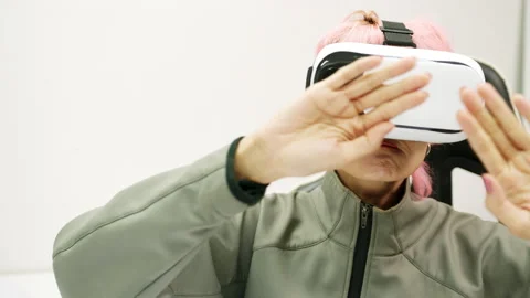 Female Using Gestures with Hands VR goggles headset modern technology Stock Footage 166436935