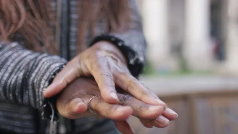 Female using hand sanitiser on her hands in the street Stock-Footage 145564806