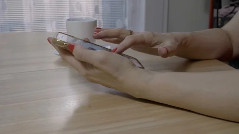 Female using her smartphone during a coffee break Stock Footage 94740143