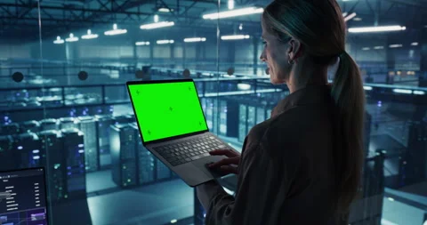 Female Using Laptop Computer with Green Screen Stock Footage 296175565