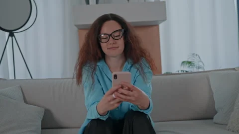 Female using mobile phone in apartment Stock Footage 245491136