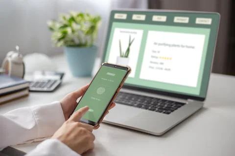 Female using mobile smart phone online payment  buy a tree successful on gree Stock Photos