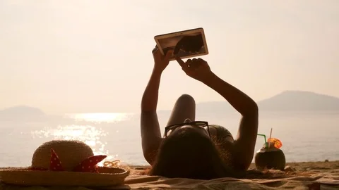 Female Using Mobile Tablet Gadget and Sunbathing on Tropical Paradise Beach. 4K Stock Footage 83448998