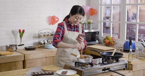 Female using phone shoot video cooking process Video stock 104086456