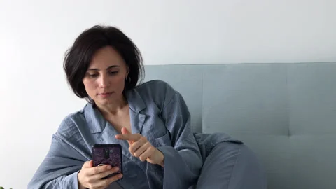 Female using phone, texting message scrolling tapping Stock Footage 196968803