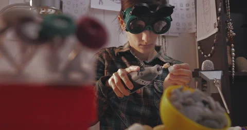 Female using pilers to producing jewelry from beads. Stock Footage 143206771