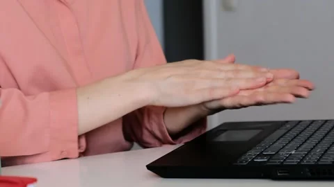Female using sanitizer on hands to protect from virus, bacteria and covid at Stock Footage 165798567