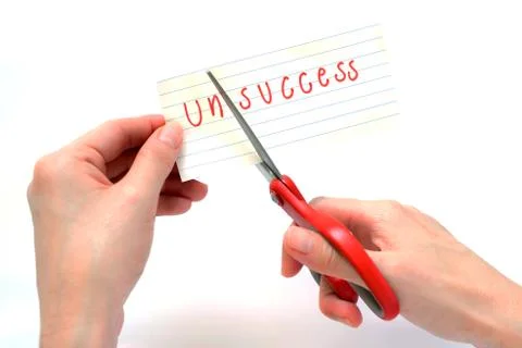 Female using scissors to remove the word unsuccess to read success concept fo Stock Photos