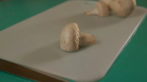 Female using sharp knife to cut champignon Stock Footage 117426766