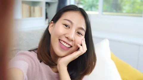 Female using smartphone making vlog video to social media in living room. Stock Footage 105723794