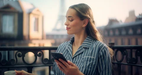 Female Using Smartphone on Paris Balcony Stock Footage 296172897