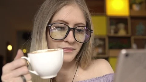 Female using smartphone while drinking coffee Video stock 83963245