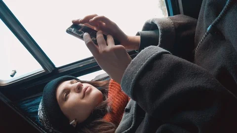 Female using smartphone while riding in a bus. Using cell phone for serching onl Video stock 123310085